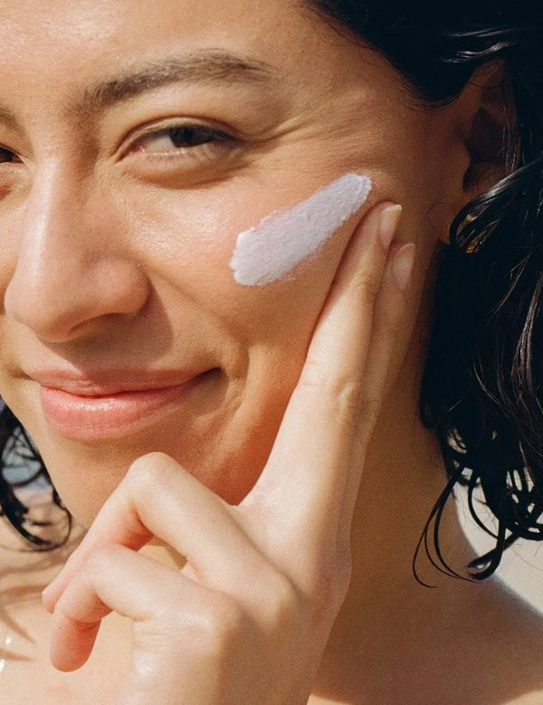 MOTHER SPF Face and Body sunscreen applied to the cheek