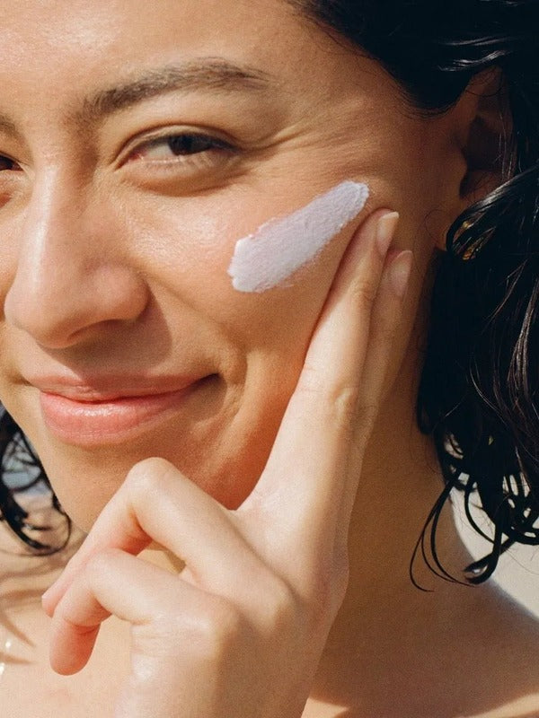 MOTHER SPF Face and Body sunscreen applied to the cheek