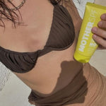 MOTHER SPF Face and Body sunscreen held in the sun