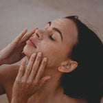 Woman receiving a facial massage with Mukti 2-in-1 Resurfacing Exfoliant