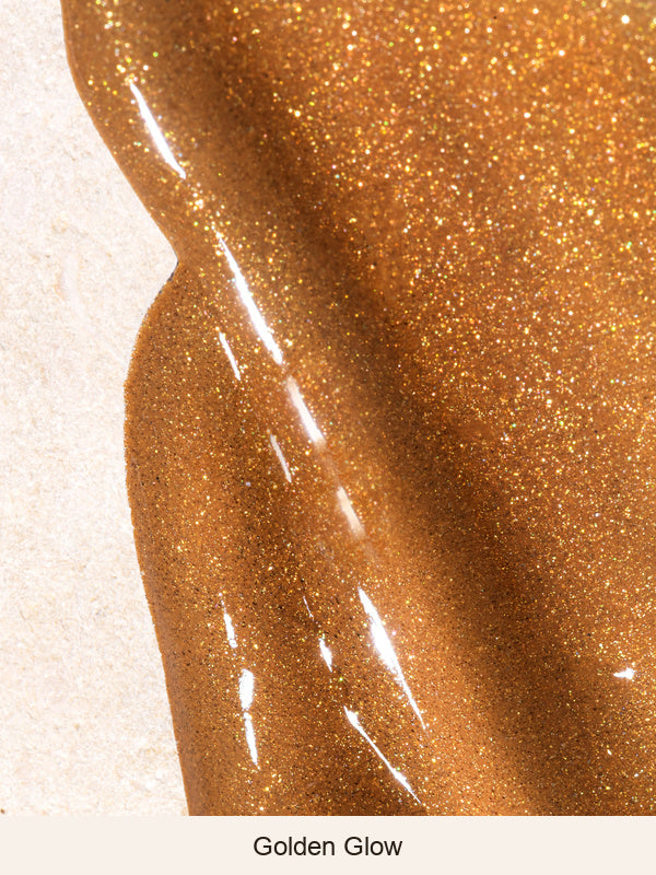 Mukti Golden Glow Bronzing Drops serum swatch showing its glossy bronze colour and fine golden shimmer on a pale textured surface, labelled Golden Glow.