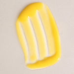 Glossy yellow swatch of Mukti Aloe Vera Moisturiser spread across a warm beige background.