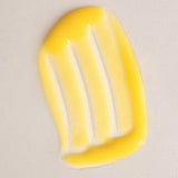 Glossy yellow swatch of Mukti Aloe Vera Moisturiser spread across a warm beige background.