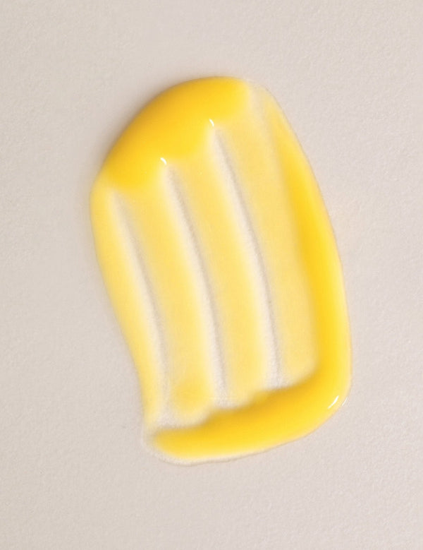 Glossy yellow swatch of Mukti Aloe Vera Moisturiser spread across a warm beige background.