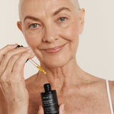 Woman applying Mukti Antioxidant Facial Oil