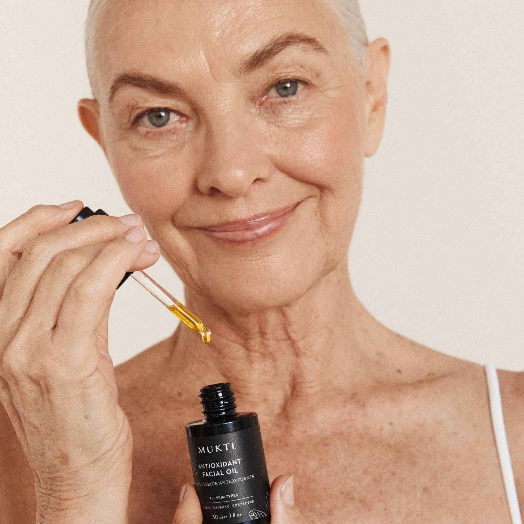 Woman applying Mukti Antioxidant Facial Oil