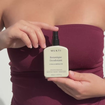 Woman holding Mukti Botanique Deodorant Citrus and Siberian Fir