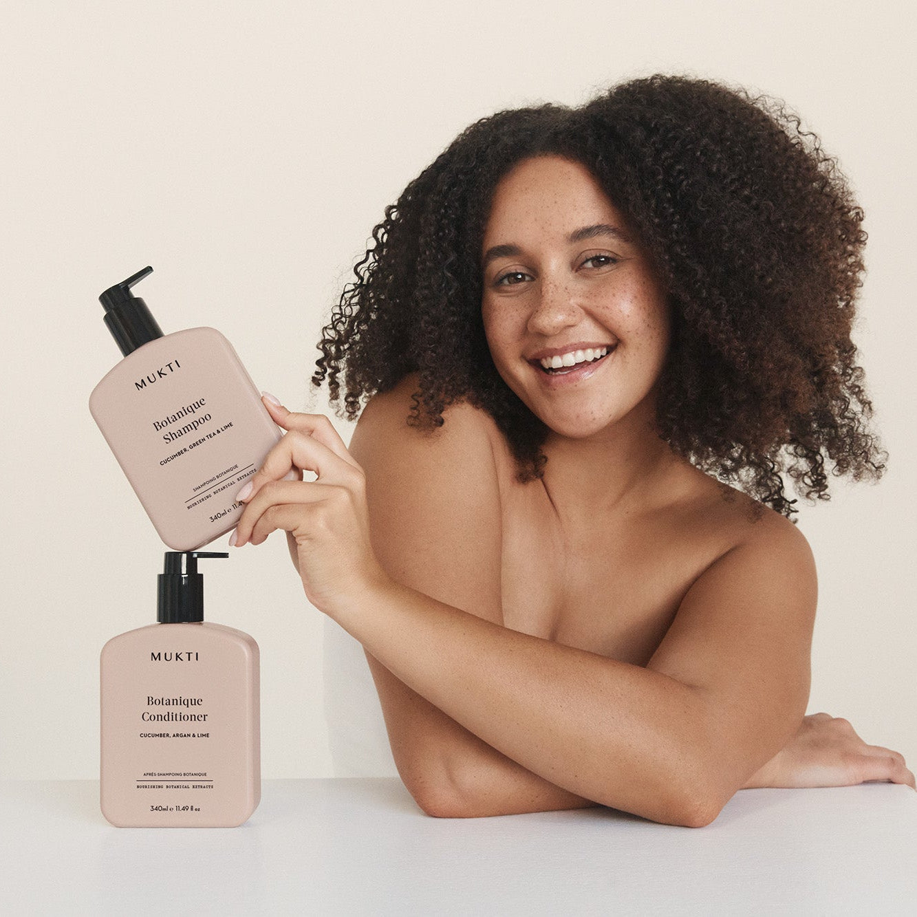 Woman holding Mukti Botanique Shampoo