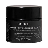 Wide black Mukti Gentle Melt Cleansing Balm jar with a glossy black lid, white lettering, outlined botanical leaves and 95g printed near the base.