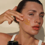 Woman applying Mukti Gentle Melt Cleansing Balm