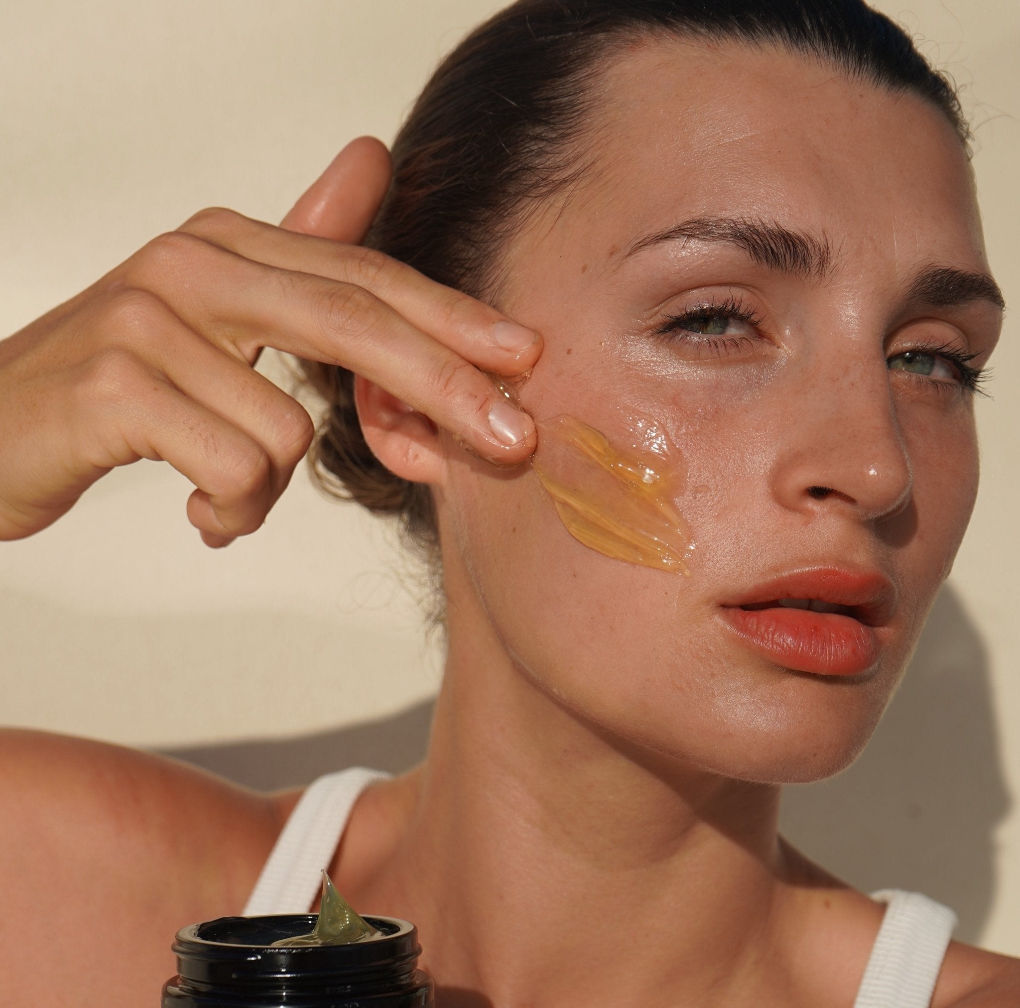 Woman applying Mukti Gentle Melt Cleansing Balm