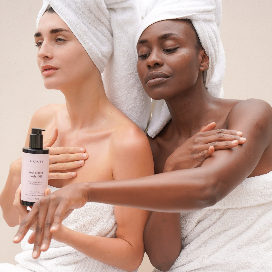 Women applying Mukti Red Velvet Body Oil