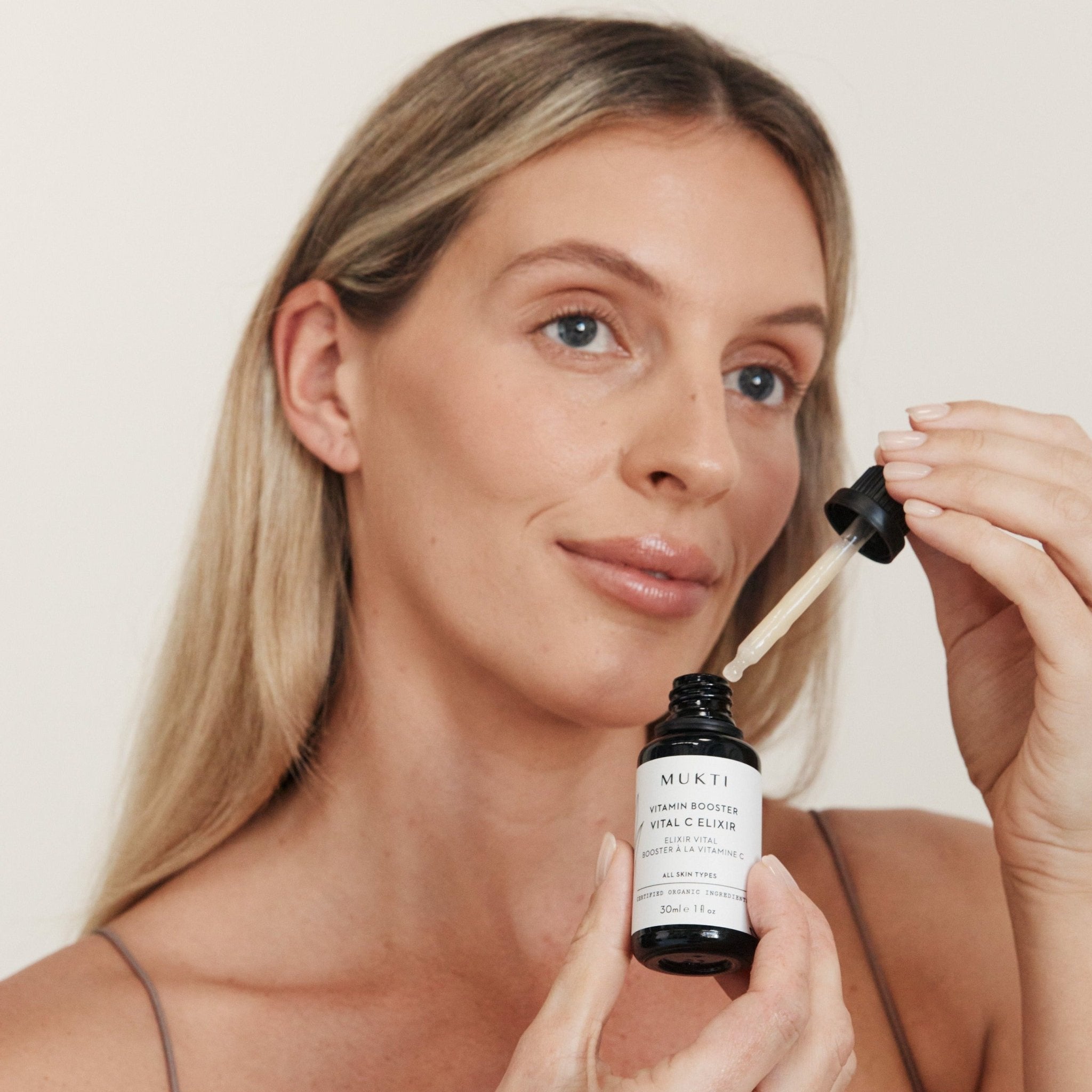 Woman applying Mukti Vitamin C Elixir