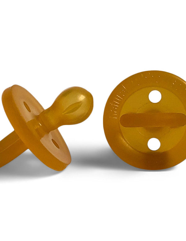 Two amber Natural Rubber Soother Large Rounded dummies shown from the side and behind, revealing the rounded teat, circular shield with two air holes, and loop handle.
