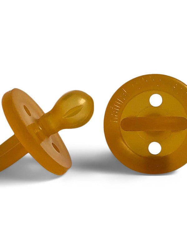 Two amber Natural Rubber Soother Large Rounded dummies shown from the side and behind, revealing the rounded teat, circular shield with two air holes, and loop handle.