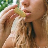 Woman applying Noosa Basics Chamomile Lip Balm
