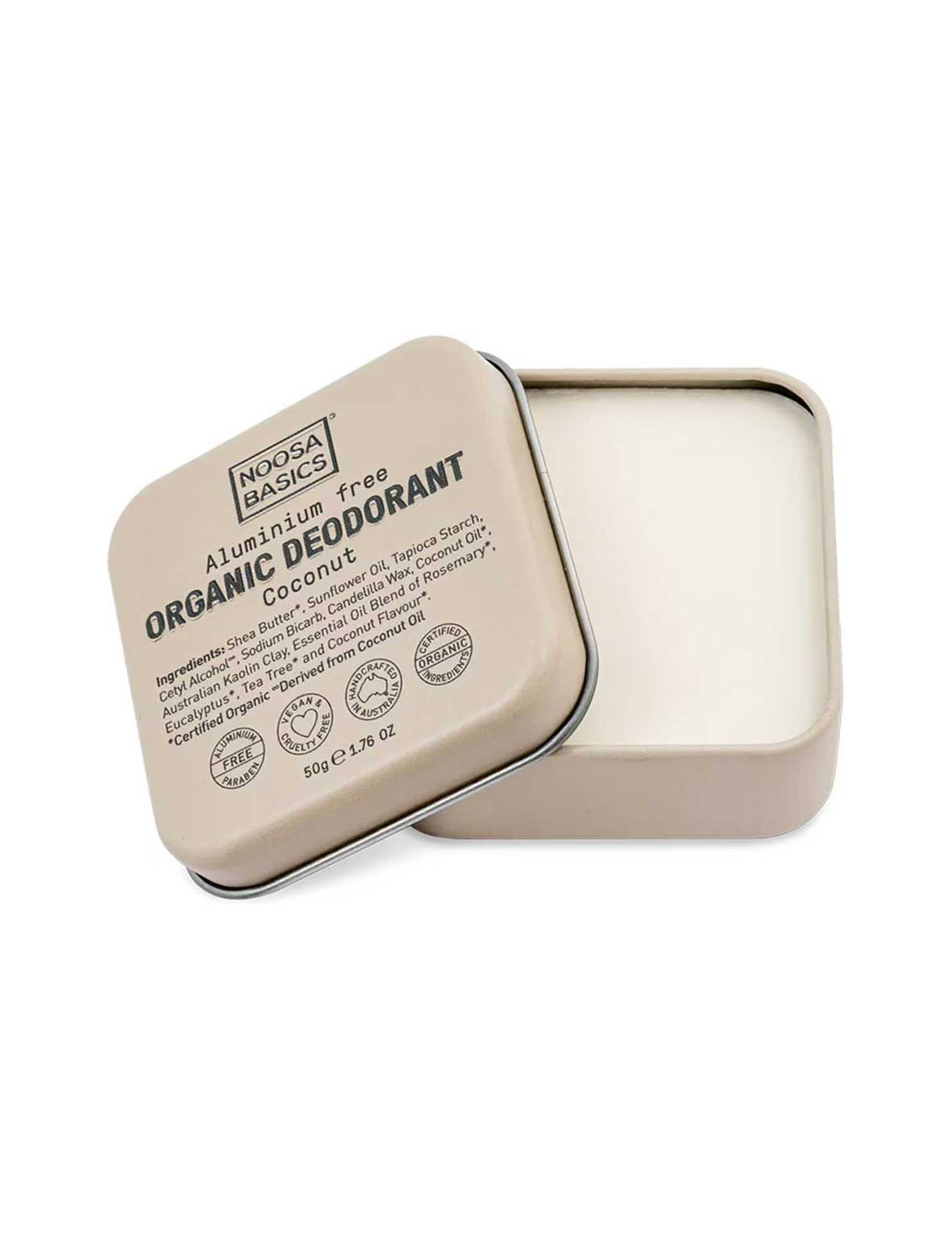 Open beige square Noosa Basics Coconut deodorant tin with rounded corners, showing smooth cream balm and its printed lid resting diagonally across the edge.
