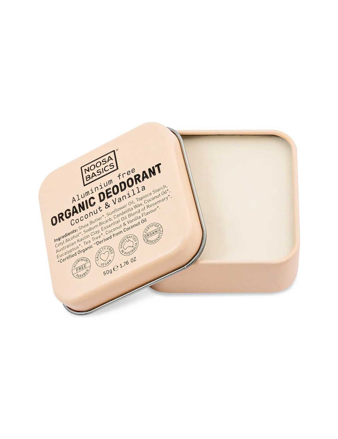 Open peach square Noosa Basics Coconut and Vanilla deodorant tin with rounded corners, showing smooth cream balm and its printed lid resting diagonally across the edge.