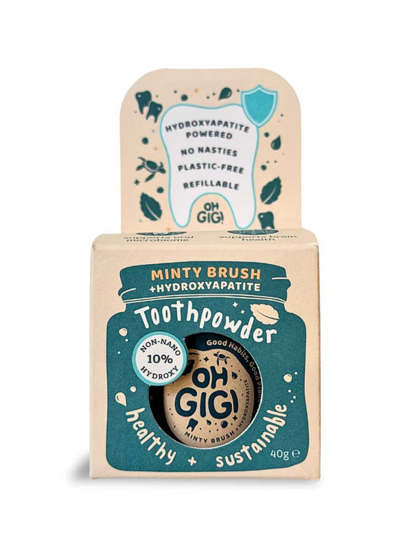 Kraft cardboard Oh Gigi Minty Brush Toothpowder box with a dark teal jar-shaped front panel and white lettering, topped by a tall tab decorated with a tooth outline and teal leaf illustrations.