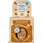 Kraft cardboard Oh Gigi Native Brush Toothpowder box with an ochre jar-shaped front panel and white lettering, topped by a tall tab decorated with a tooth outline and ochre botanical illustrations.