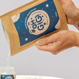 Oh Gigi Minty Hydroxyapatite Tooth Powder refill being poured into its glass jar
