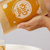 Oh Gigi Native Hydroxyapatite Tooth Powder refill being poured into its glass jar