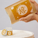 Oh Gigi Native Hydroxyapatite Tooth Powder refill being poured into its glass jar
