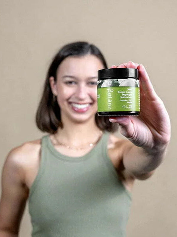 Botani Olive Repair Cream 120g — model holding olive repair cream