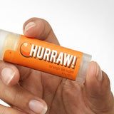 Hand holding Hurraw! Organic Lip Balm - Orange 4.8g
