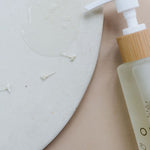 Orgaid Cleansing Oil styled on a bathroom vanity