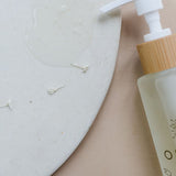 Orgaid Cleansing Oil styled on a bathroom vanity