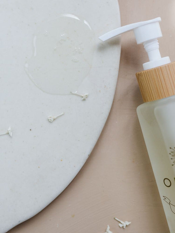 Orgaid Cleansing Oil styled on a bathroom vanity