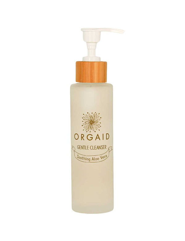 A clear frosted 120ml Orgaid Gentle Cleanser bottle with a pump and wooden accent, labeled "Soothing Aloe Vera," is ideal for sensitive skin and is displayed against a white background.
