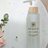 Orgaid Gentle Cleanser styled with flowers on a bathroom vanity