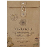 Kraft paper Orgaid Anti-Aging and Moisturising sheet-mask envelope with a string-and-button fastening, a black flower emblem and fine botanical drawings along the lower corners.