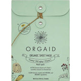 Mint-green Orgaid Firming, Anti-Aging and Vitamin C sheet-mask envelope with a string-and-button fastening, a black flower emblem and fine botanical drawings along the lower corners.
