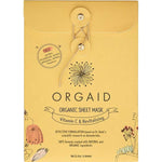 Golden-yellow Orgaid Vitamin C and Revitalising sheet-mask envelope with a string-and-button fastening, a black flower emblem and fine botanical drawings along the lower corners.