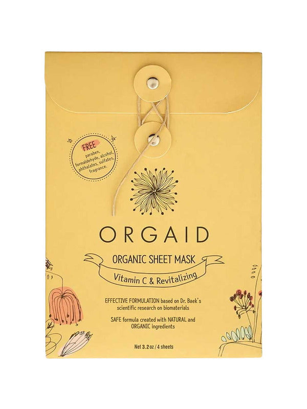 Golden-yellow Orgaid Vitamin C and Revitalising sheet-mask envelope with a string-and-button fastening, a black flower emblem and fine botanical drawings along the lower corners.