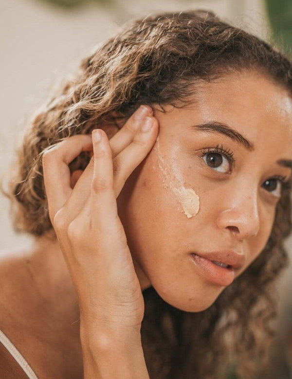 Woman applying Orgaid Purifying Face Polish to her cheek