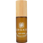 A 36ml brown glass bottle of Orgaid Youth Serum Hyaluronic and Vitamin C with a wooden cap, featuring a flower graphic label. This vitamin C serum blend helps brighten skin.
