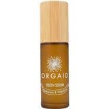 A 36ml brown glass bottle of Orgaid Youth Serum Hyaluronic and Vitamin C with a wooden cap, featuring a flower graphic label. This vitamin C serum blend helps brighten skin.