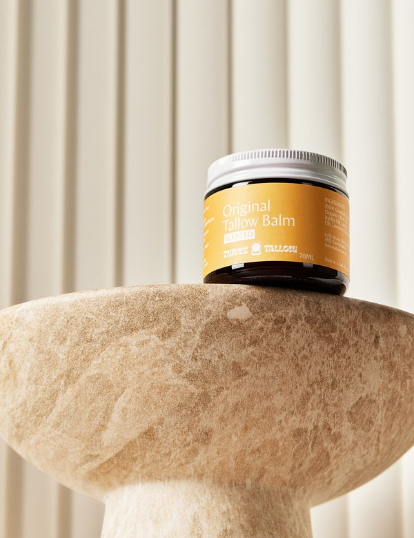 Original Tallow Balm jar displayed on a stone pedestal – Thrive Tallow Original Tallow Balm Scented 70ml