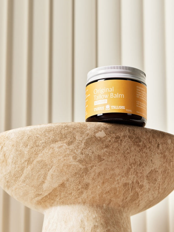 Original Tallow Balm jar displayed on a stone pedestal – Thrive Tallow Original Tallow Balm Scented 70ml