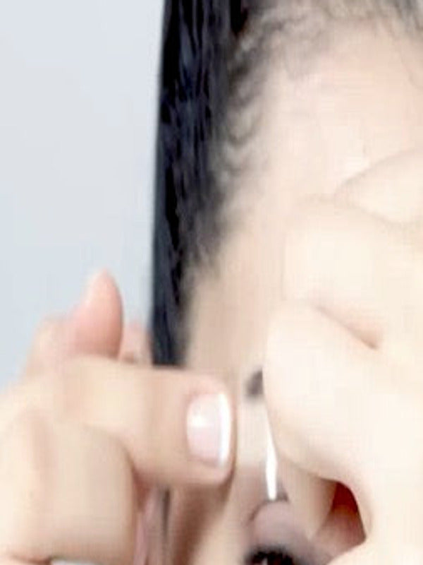 Close-up of a Parissa Brow Wax Strip being positioned and pressed along the eyebrow.