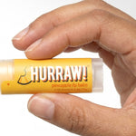 Hand holding Hurraw! Organic Lip Balm - Pineapple 4.8g