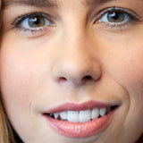 A close-up of a smiling woman with light skin, brown eyes, and pink lips wearing Luk Beautifood Lip Nourish Lipsticks 3g. The text Pink Juniper appears at the bottom of the image.