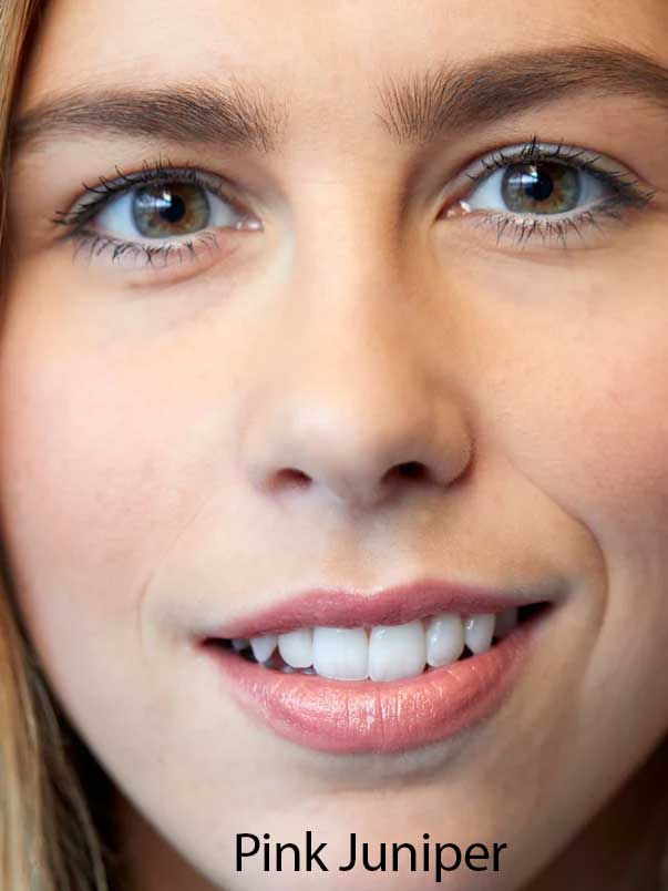 A close-up of a smiling woman with light skin, brown eyes, and pink lips wearing Luk Beautifood Lip Nourish Lipsticks 3g. The text Pink Juniper appears at the bottom of the image.