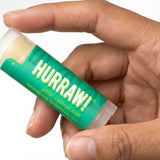 Hand holding Hurraw! Pitta Lip Balm Coconut Mint & Lemongrass 4.8g