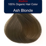Teardrop-shaped tuft of smooth, muted brown hair beneath a navy label reading Radico 100% Organic Hair Color, Ash Blonde.