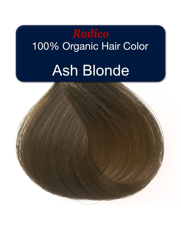 Teardrop-shaped tuft of smooth, muted brown hair beneath a navy label reading Radico 100% Organic Hair Color, Ash Blonde.